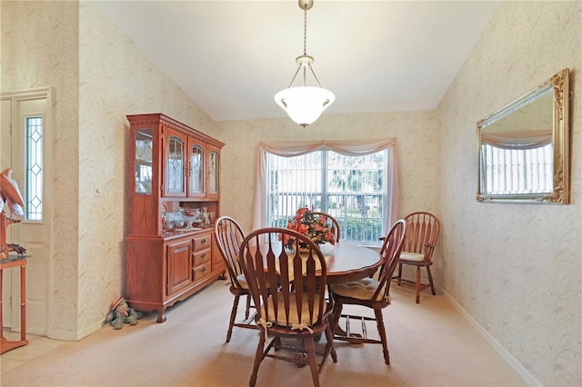 dining area featuring wallpapered walls and light carpet