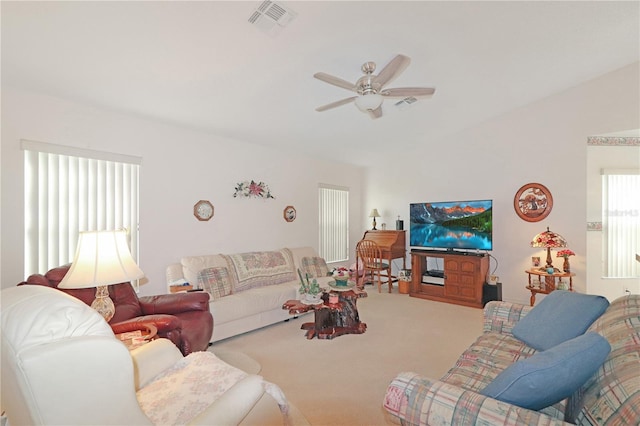 living area featuring visible vents, a ceiling fan, carpet, and vaulted ceiling