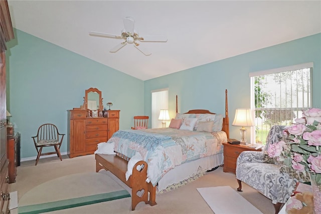 bedroom featuring a ceiling fan, vaulted ceiling, and carpet
