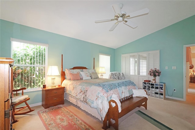 bedroom featuring light colored carpet, baseboards, vaulted ceiling, and multiple windows