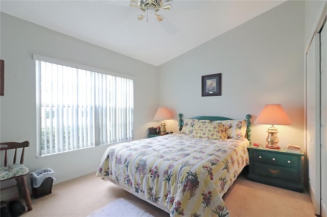 bedroom with a closet, carpet flooring, a ceiling fan, and lofted ceiling