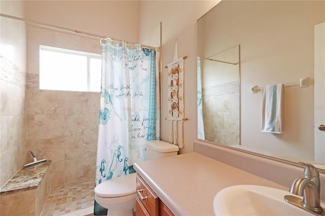 bathroom featuring toilet, a walk in shower, and vanity