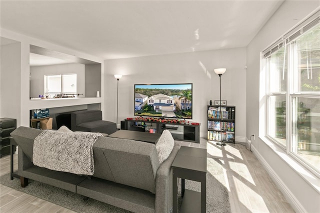 living room featuring plenty of natural light and light wood-type flooring