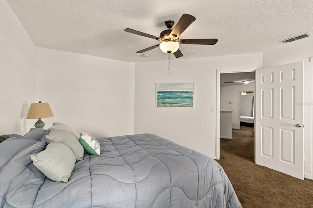 carpeted bedroom featuring ceiling fan and a textured ceiling