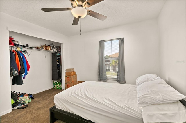 carpeted bedroom with ceiling fan, a textured ceiling, and a closet