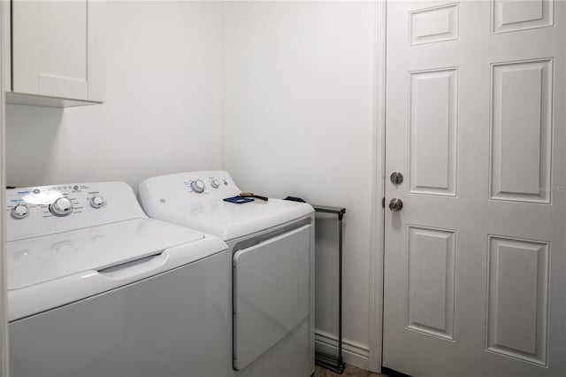 washroom with cabinets and independent washer and dryer