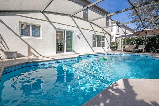 view of pool with glass enclosure