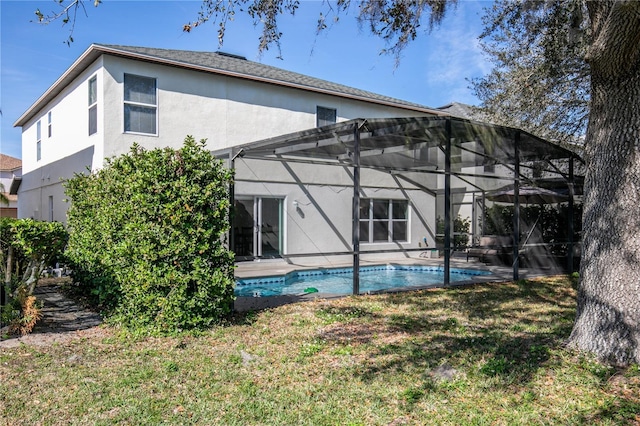 back of house with a yard, a lanai, and a patio