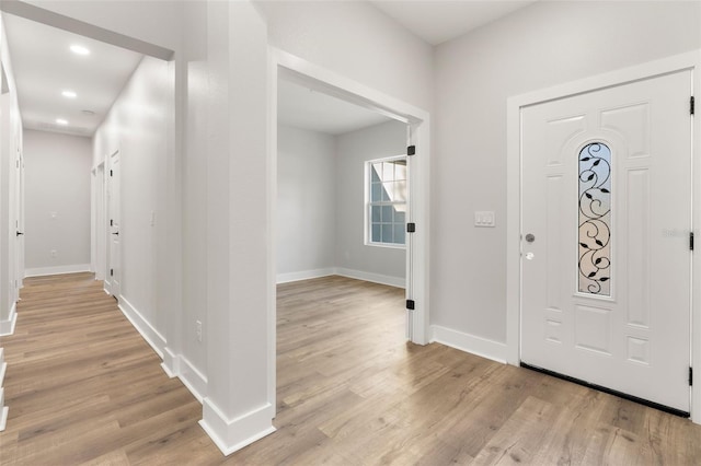 foyer entrance with recessed lighting, light wood-style floors, and baseboards