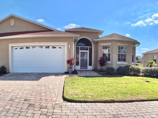 view of front of property featuring a garage and a front lawn