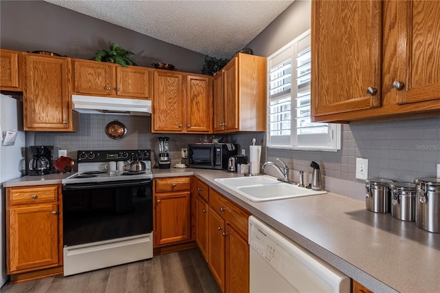 kitchen featuring sink, electric range oven, dark hardwood / wood-style floors, white dishwasher, and a textured ceiling