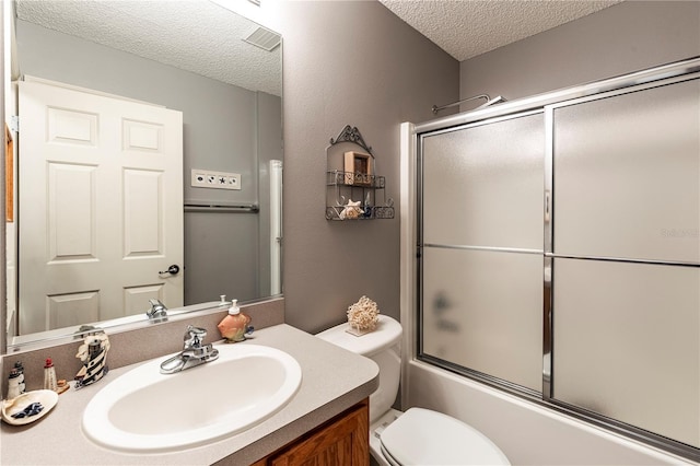 full bathroom with vanity, toilet, enclosed tub / shower combo, and a textured ceiling