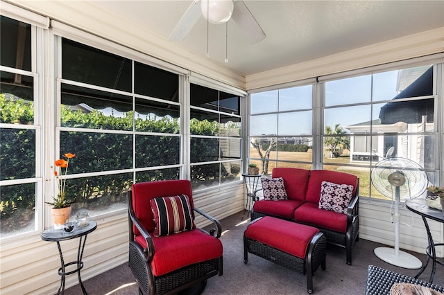 sunroom / solarium featuring ceiling fan