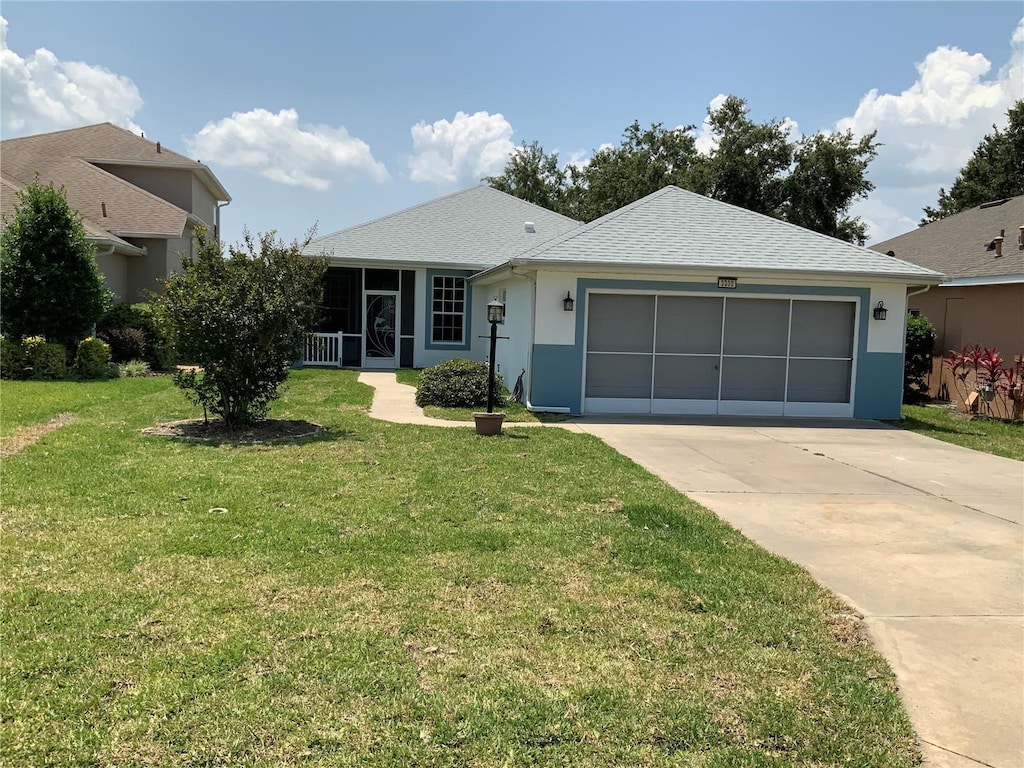 view of front of property featuring a garage and a front lawn