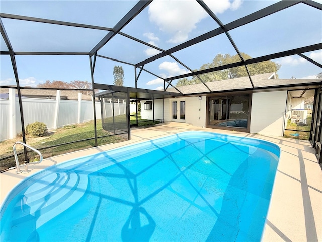 view of swimming pool with a patio and glass enclosure