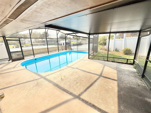 view of swimming pool with a lanai and a patio area