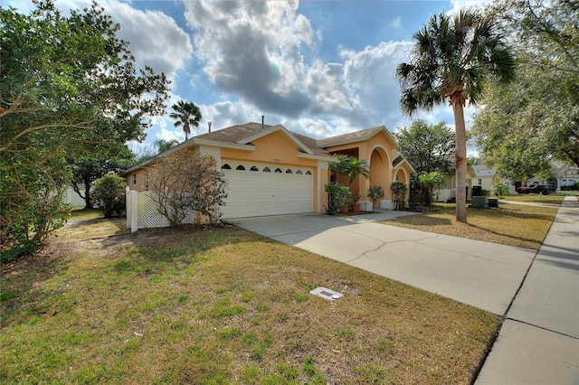 view of front of property with a garage and a front yard