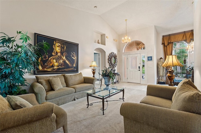 living room with light colored carpet, high vaulted ceiling, and a notable chandelier