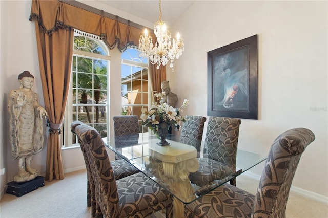 dining room with light carpet and a notable chandelier