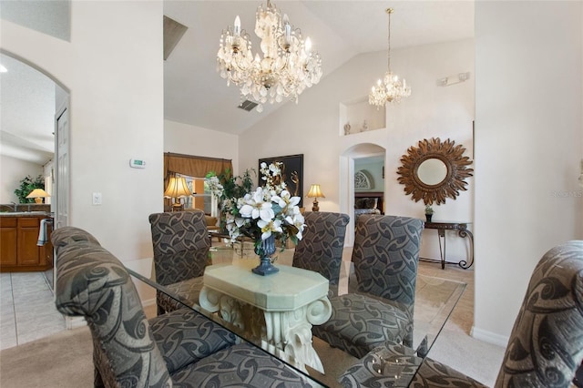 carpeted dining area featuring sink, high vaulted ceiling, and a chandelier