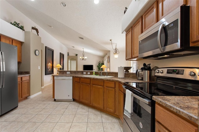 kitchen with pendant lighting, sink, lofted ceiling, stainless steel appliances, and light tile patterned flooring