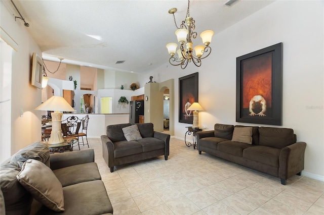 tiled living room featuring an inviting chandelier and lofted ceiling