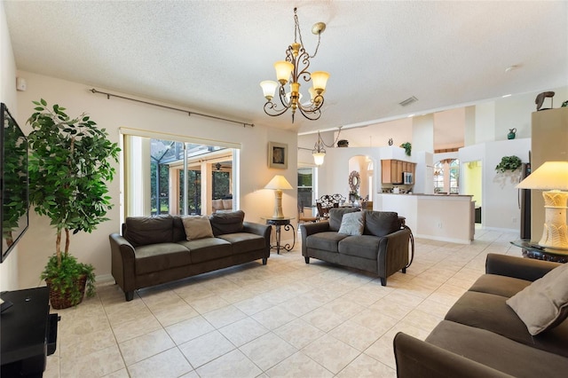 tiled living room with a chandelier and a textured ceiling