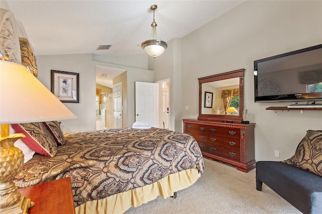 bedroom featuring vaulted ceiling, carpet floors, and ensuite bathroom