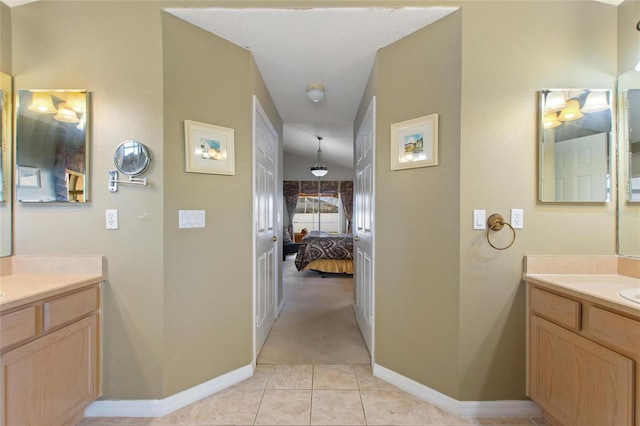 bathroom with vanity, tile patterned floors, and a textured ceiling