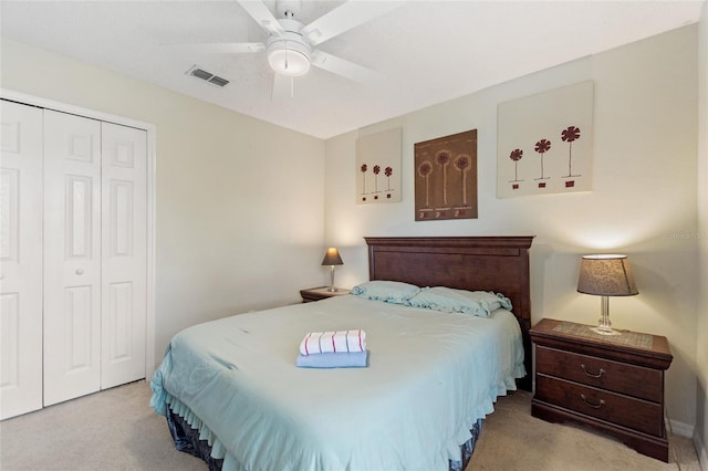 carpeted bedroom featuring ceiling fan and a closet