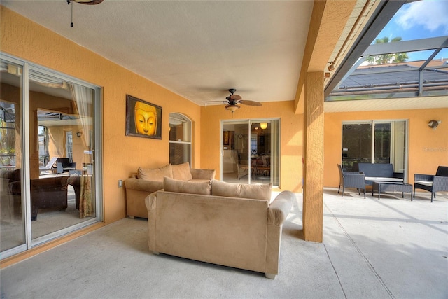 living room featuring concrete flooring and ceiling fan