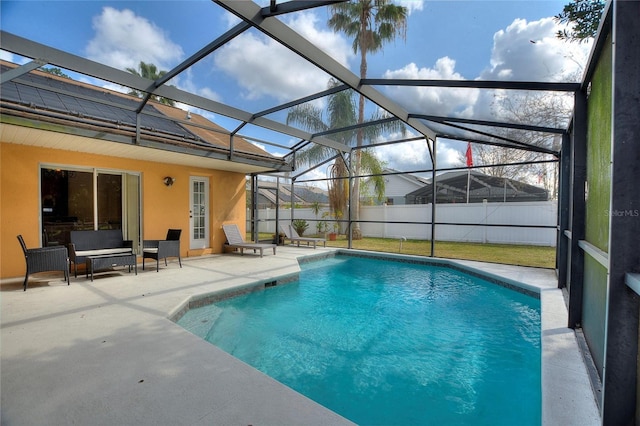 view of pool with a patio area and glass enclosure