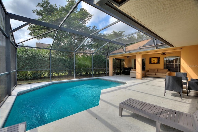 view of pool featuring ceiling fan, an outdoor hangout area, glass enclosure, and a patio area