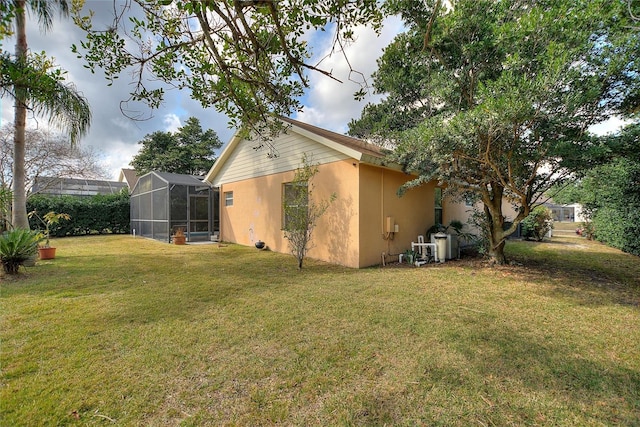 exterior space with a lanai and a yard