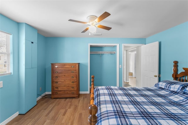 bedroom with a closet, ceiling fan, and light wood-type flooring