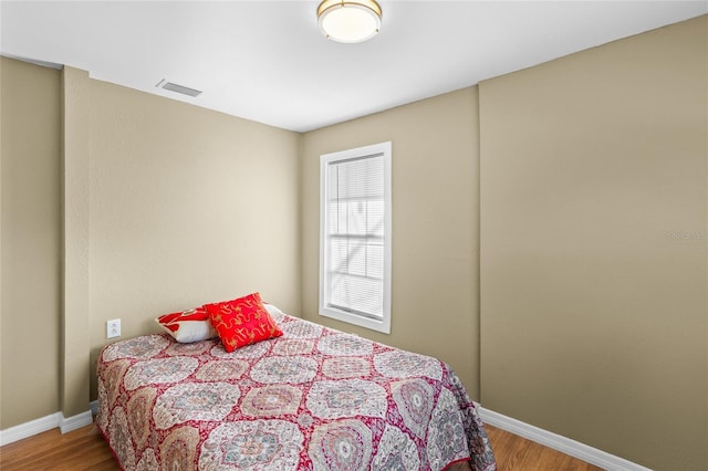 bedroom with hardwood / wood-style flooring