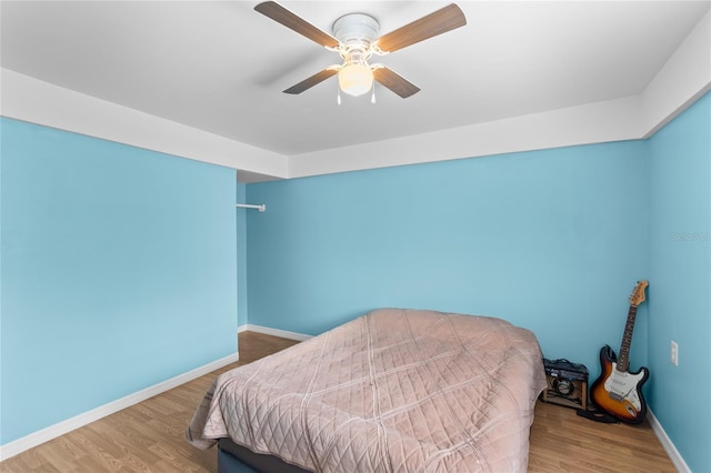 bedroom featuring hardwood / wood-style flooring and ceiling fan