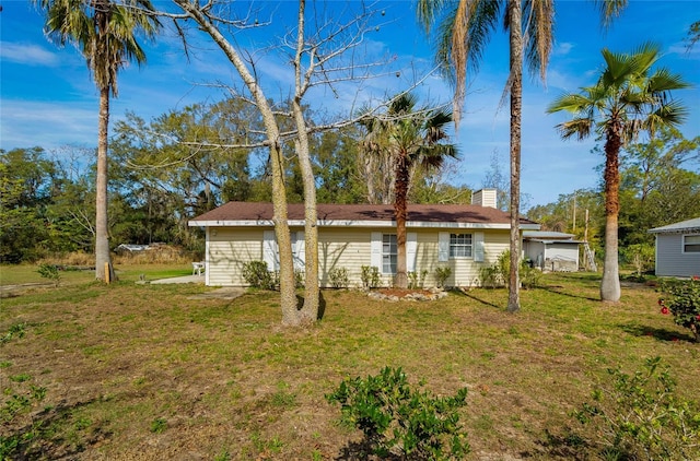 rear view of property with a lawn