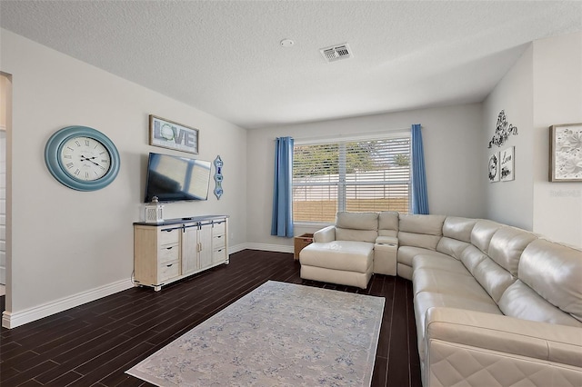 living room featuring dark hardwood / wood-style floors and a textured ceiling