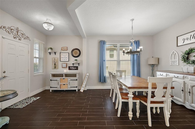 dining space featuring a chandelier and a textured ceiling