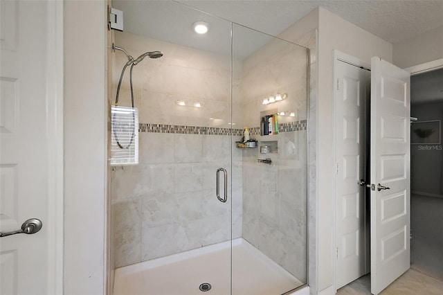 bathroom featuring a shower with shower door