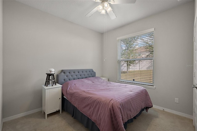 bedroom featuring light colored carpet and ceiling fan