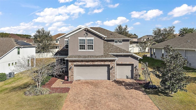 view of front property featuring a garage, a front lawn, and central air condition unit