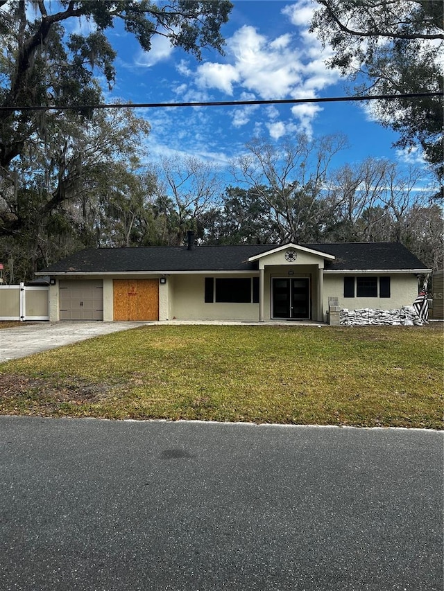 ranch-style house featuring a garage and a front yard