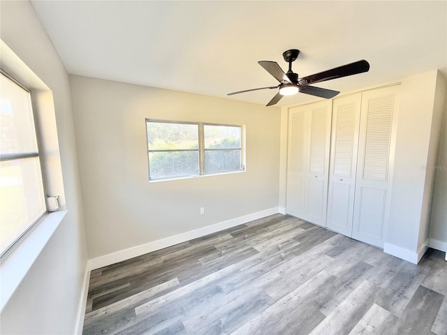 unfurnished bedroom with ceiling fan, light hardwood / wood-style floors, and a closet