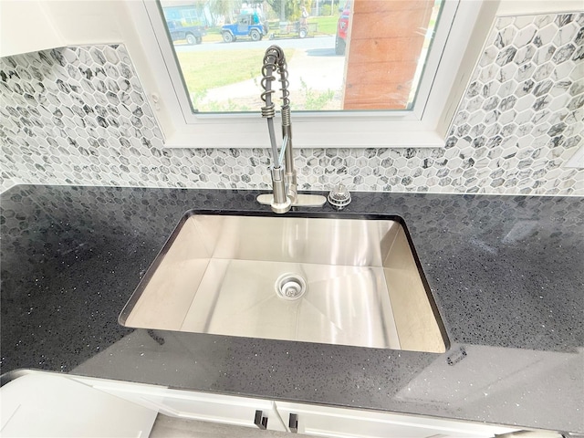 room details featuring sink and white cabinets