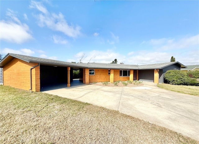 ranch-style home with a carport and a front lawn