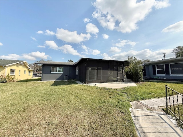 back of property featuring a patio, central AC unit, and a lawn