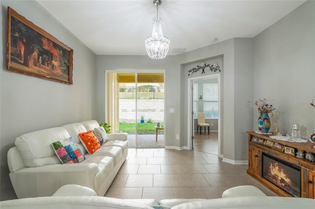 17523 Promenade Dr, Clermont, FL 34711 - tiled living room featuring a notable chandelier