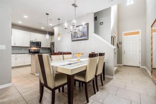 17523 Promenade Dr, Clermont, FL 34711 - tiled dining space with a high ceiling and a chandelier